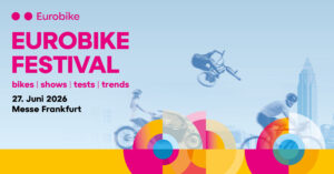 Eurobike Festival poster: large pink 'EUROBIKE FESTIVAL' text, bikes in motion, city skyline, and colorful circular designs on a blue gradient background.